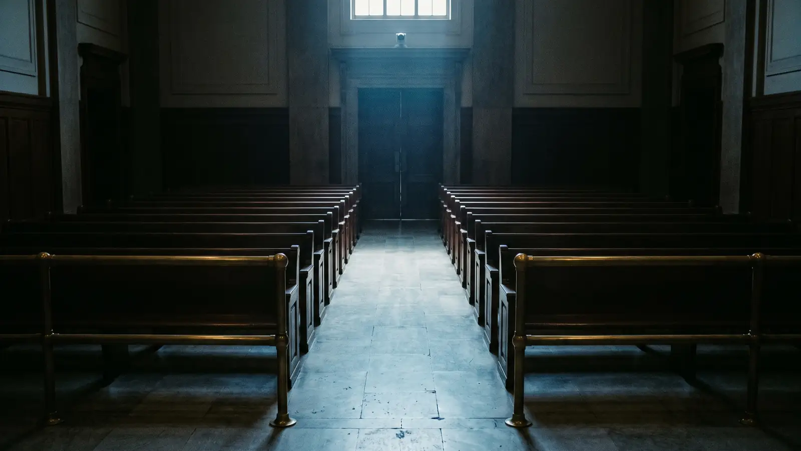 An empty courtroom gallery at night.